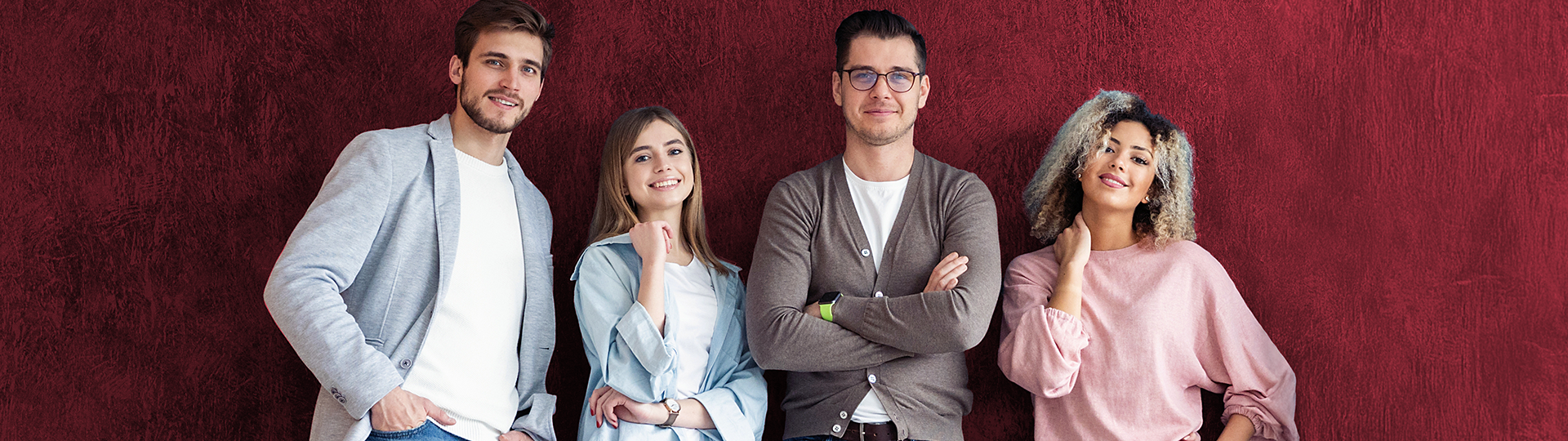Teamfoto mit vier Personen vor rotem Hintergrund für die Stelle Assistenz der Geschäftsführung m w d